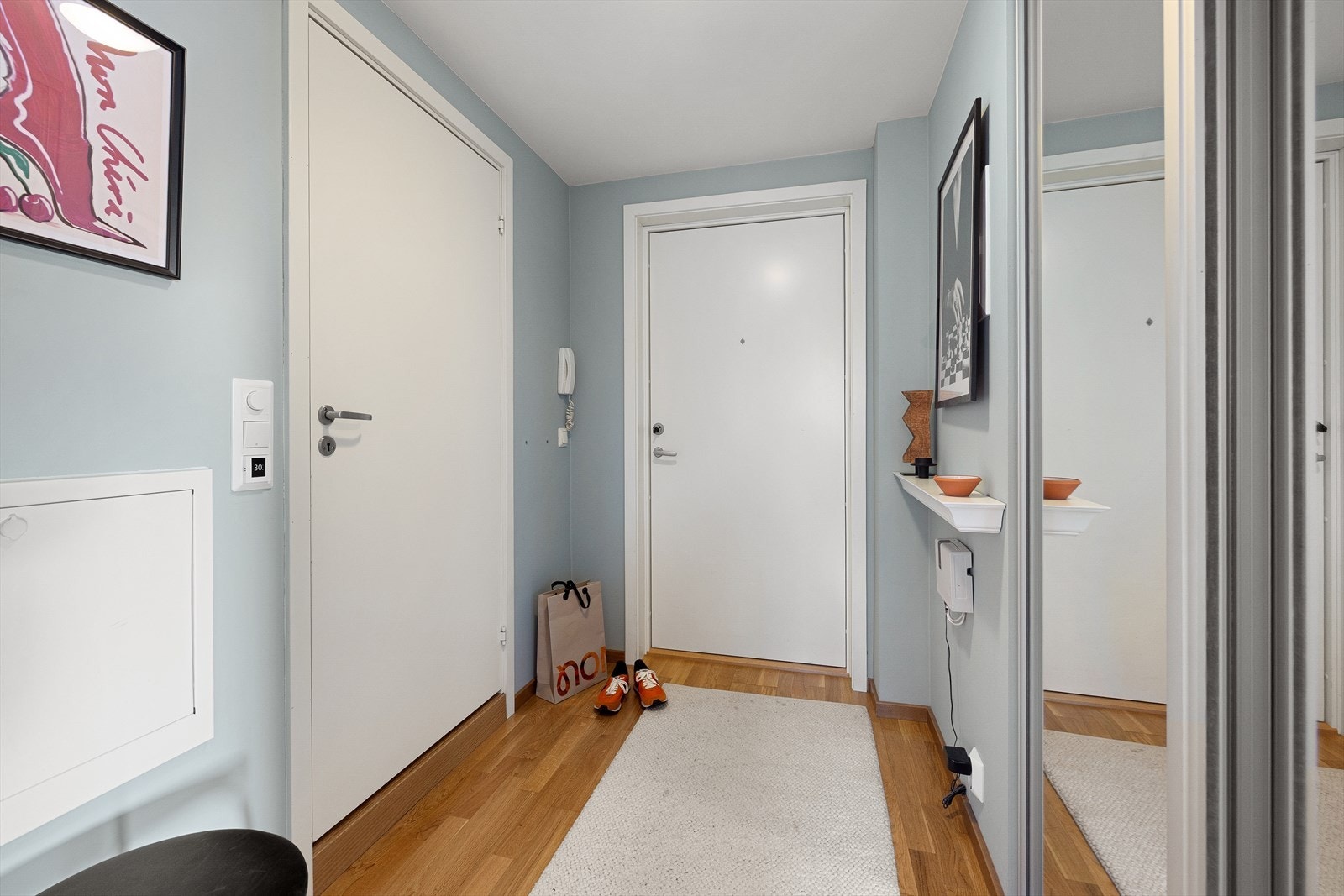 Innbydende og lys entré med skyvedørsgarderobe til å henge fra seg yttertøy, og plass til skohylle. Galleribilde