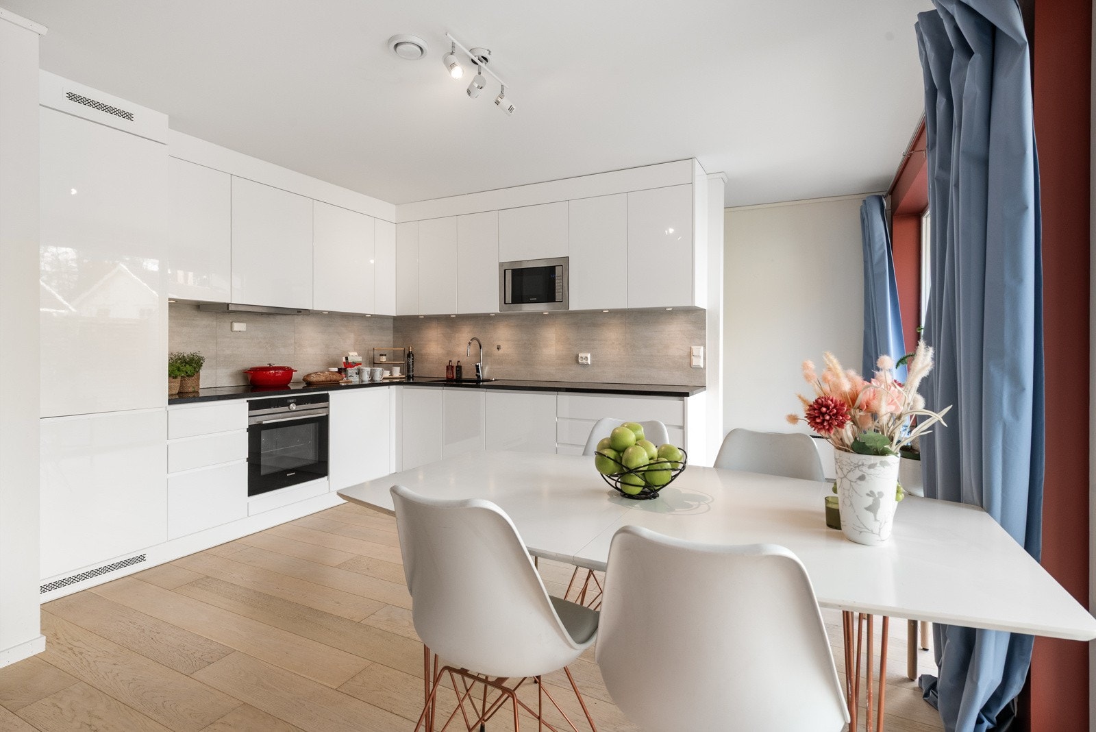 Kjøkkenet utgjør en mer tilbaketrukket avdeling av den åpne løsningen i en praktisk L-form. Galleribilde