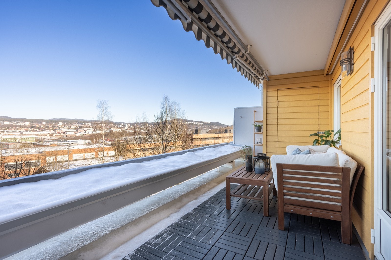 Terrassen er delvis kledd med terrasseheller som gir et pent og praktisk underlag for utemøbler og planter Galleribilde