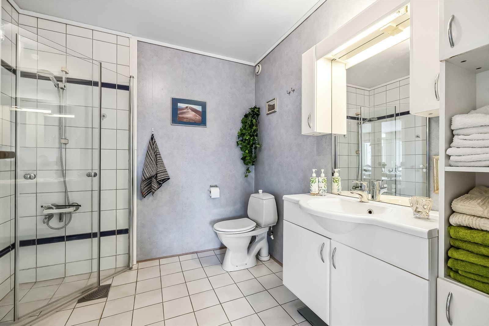 På badet er det montert dusjvegger, et toalett og en baderomsinnredning. Galleribilde