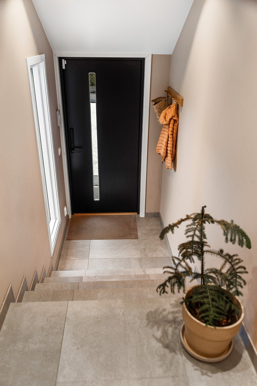 Entreen ble pusset opp i 2021, med gulvvarme, fliser og downlights. Galleribilde