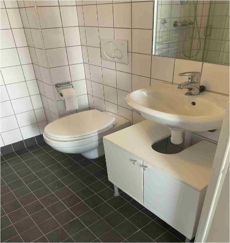 Bad med dusjhjørne og vaskemaskin. Galleribilde