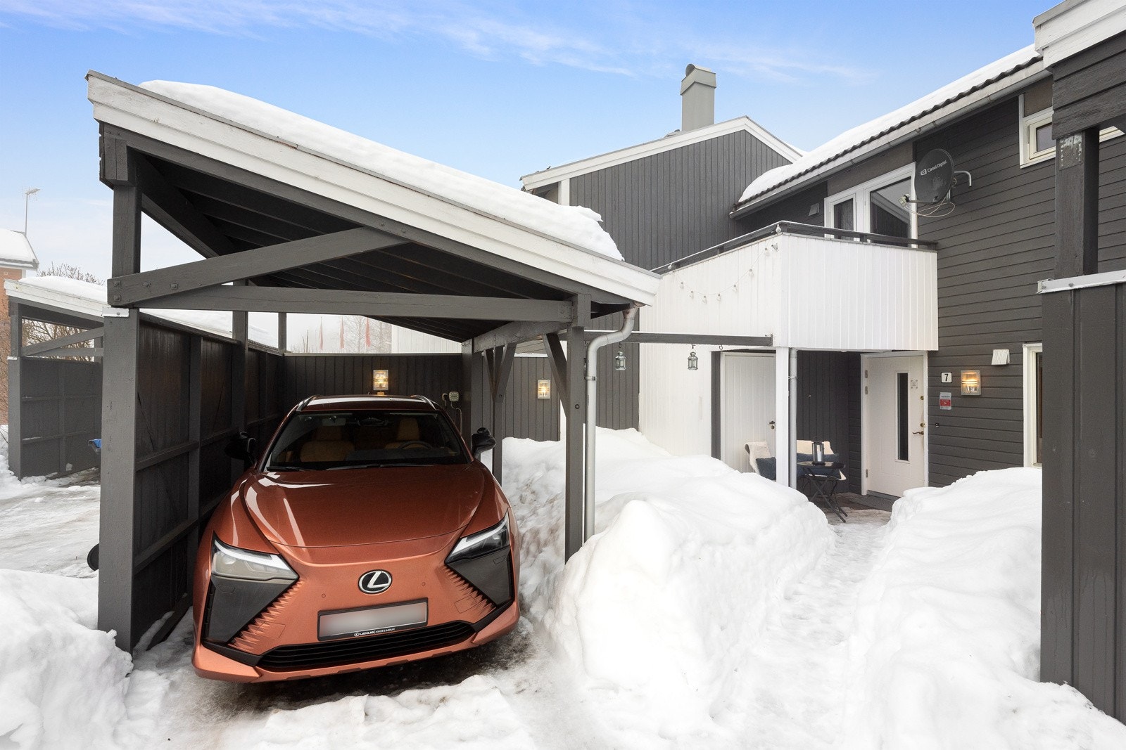 Det er parkering for en bil i carport rett utenfor boligen. Galleribilde