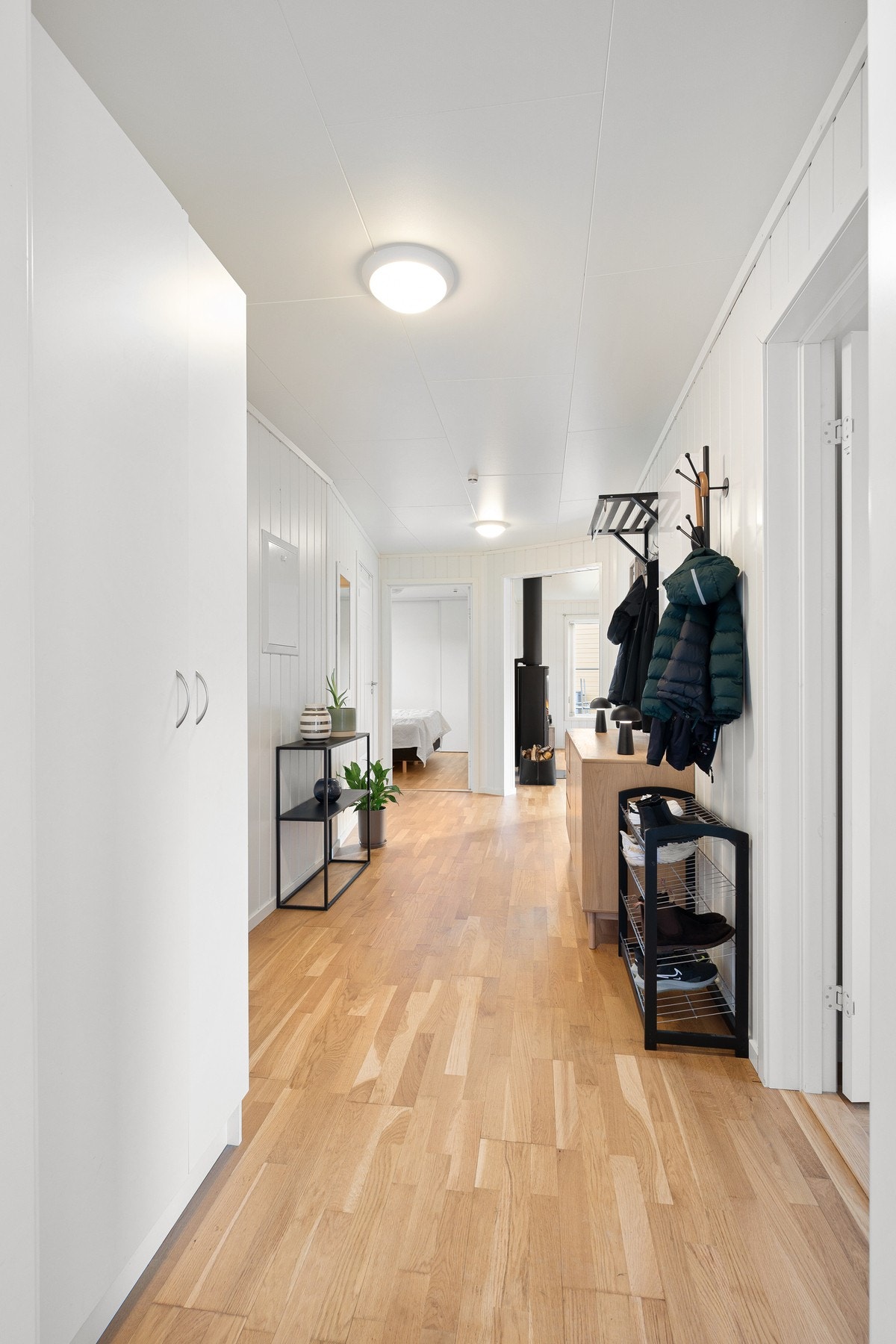 Innbydende gang med god plass til både yttertøy og møblement, her innredet med både kommode og pyntegjenstander Galleribilde