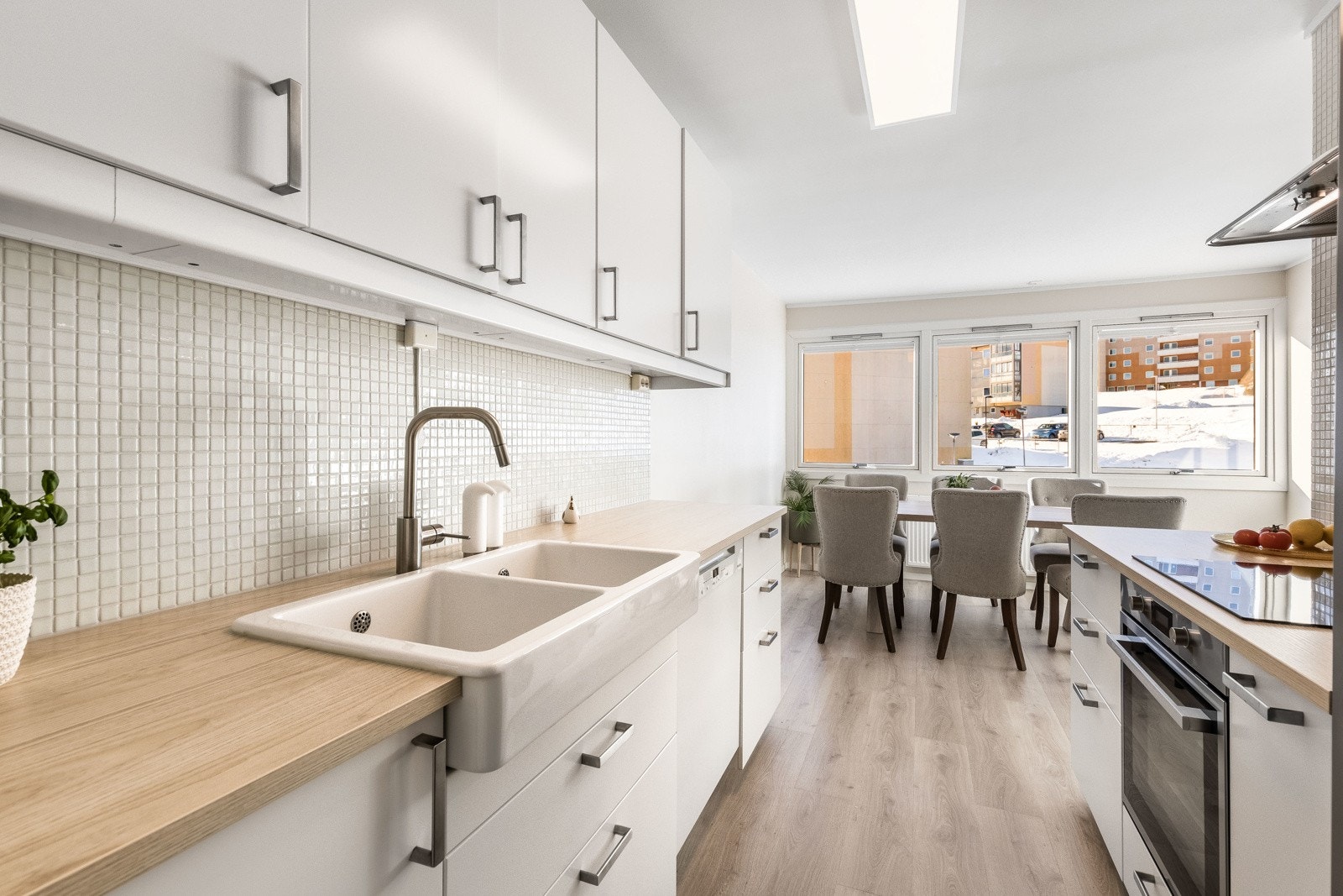 Innredningen er fra Ikea og har hvite, slette fronter, treimiterte benkeplater og mosaikkfliser på veggene. Galleribilde