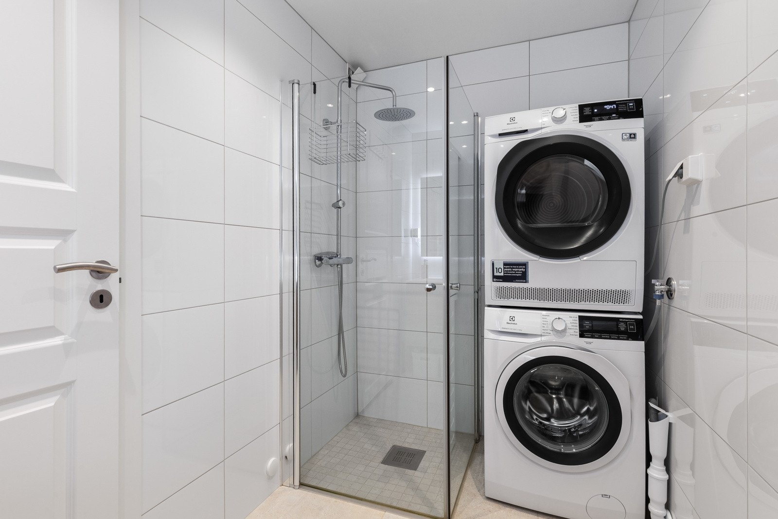 I det ene hjørnet er det dusj med innfellbare glassdører, regnfallsdusj og hånddusj. Videre er badet utstyrt med opplegg for vaskemaskin/tørketrommel. Galleribilde