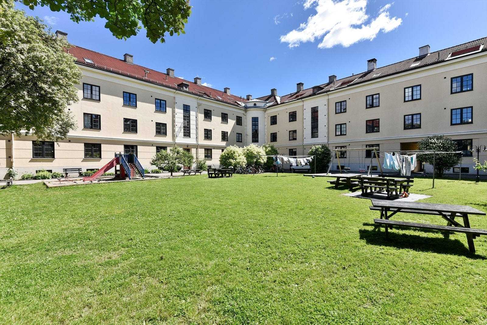 Borettslaget har en idyllisk bakgård med felles grill og lekeapparater perfekt for sosiale sammenkomster Galleribilde