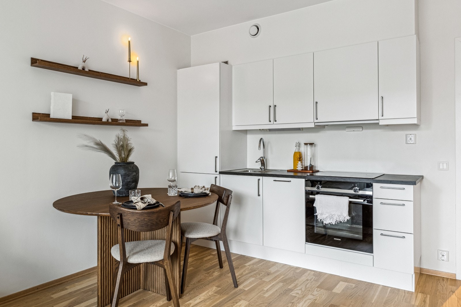 Nytt og moderne kjøkken med integrerte hvitevarer - stekeovn, platetopp, oppvaskmaskin og kjøleskap med fryser. Galleribilde