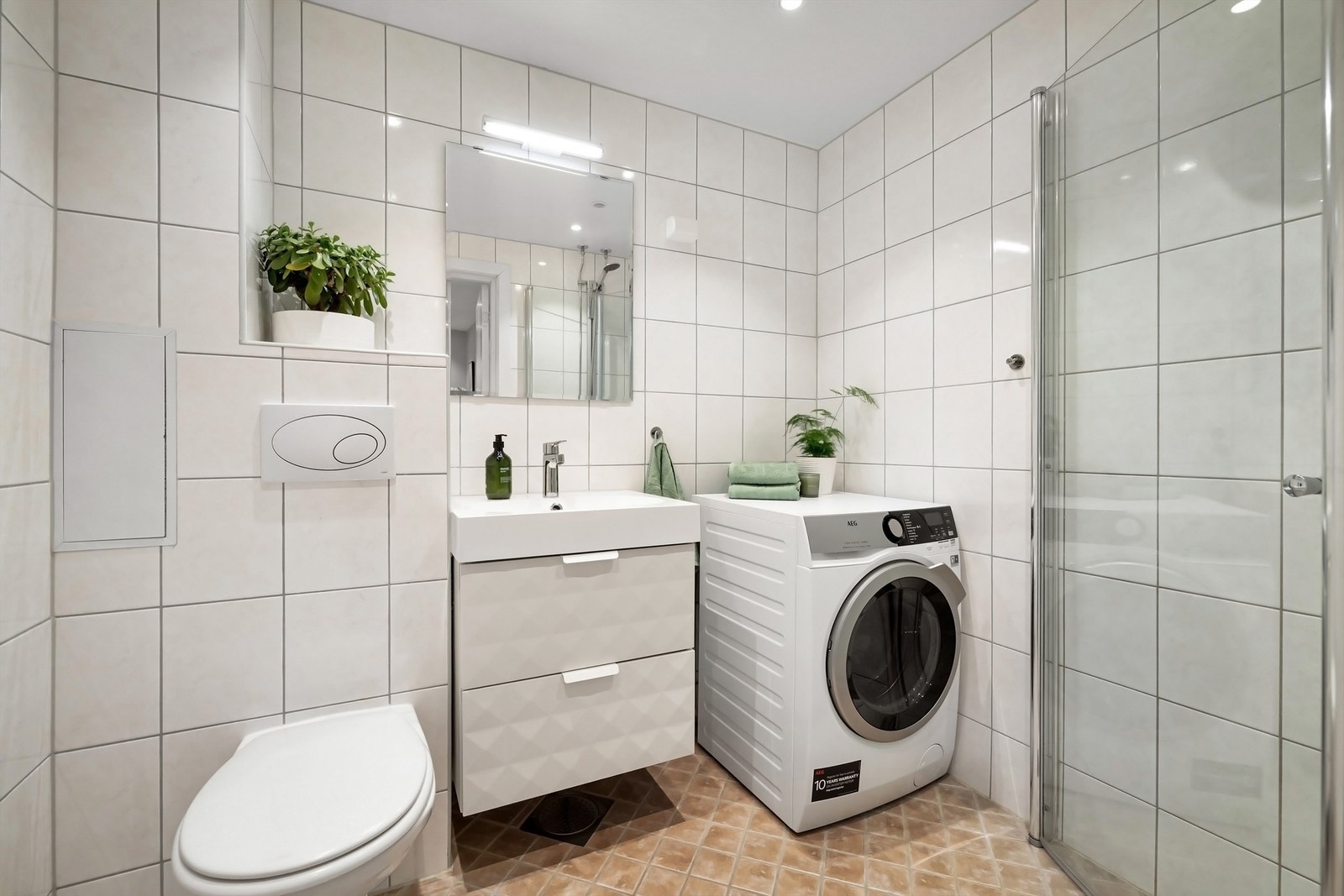 Pent, flislagt bad med gulvvarme og downlights i himling renovert i regi av borettslaget i 2010. Opplegg og plass til vaskemaskin og tørketrommel Galleribilde