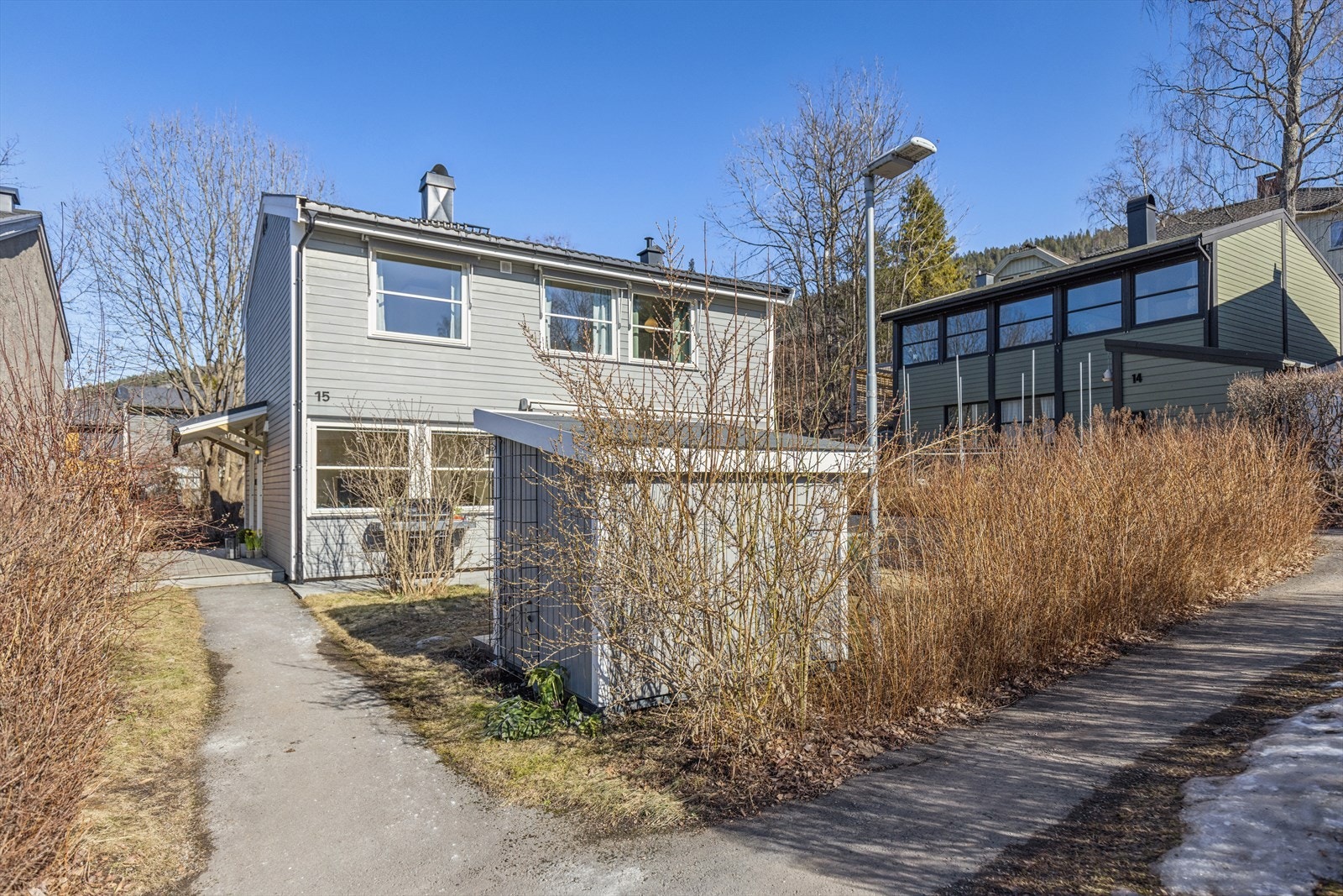 Boligen ligger usjenert og tilbaketrukket på feltet med hekk og lekestue som naturlig skjerming for innsyn Galleribilde