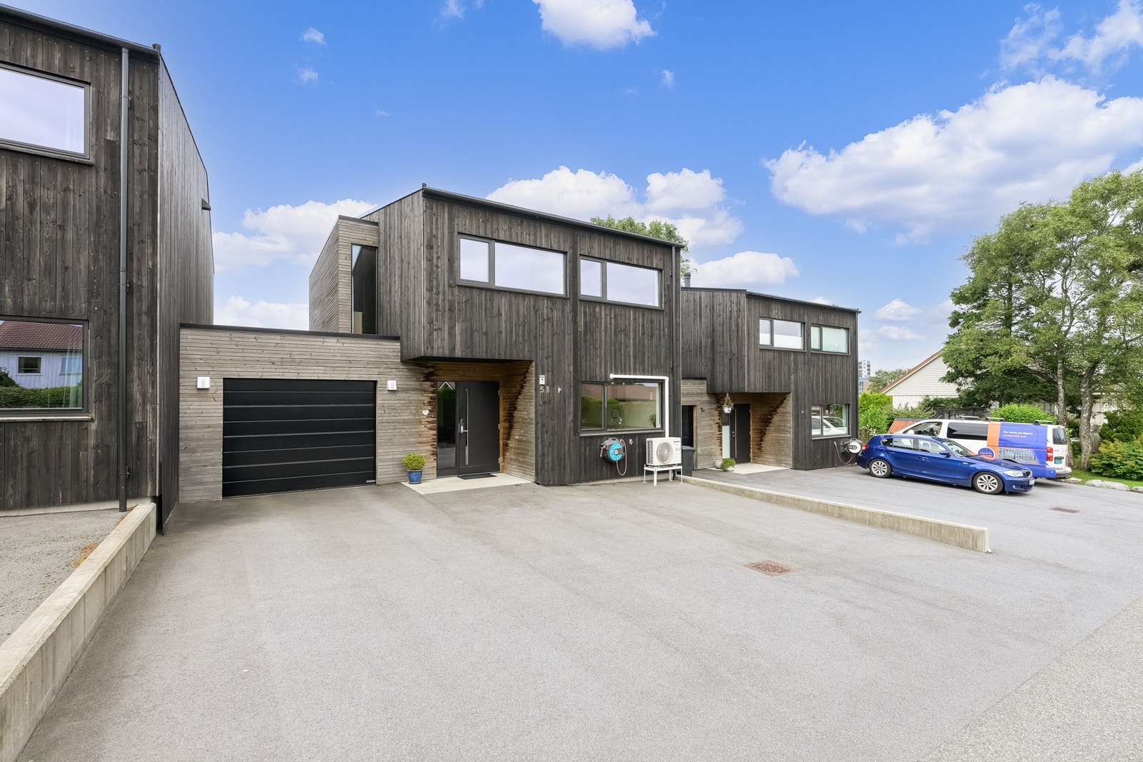 Biloppstillingsplass i garasje med el-billader og gårdsrom. Galleribilde