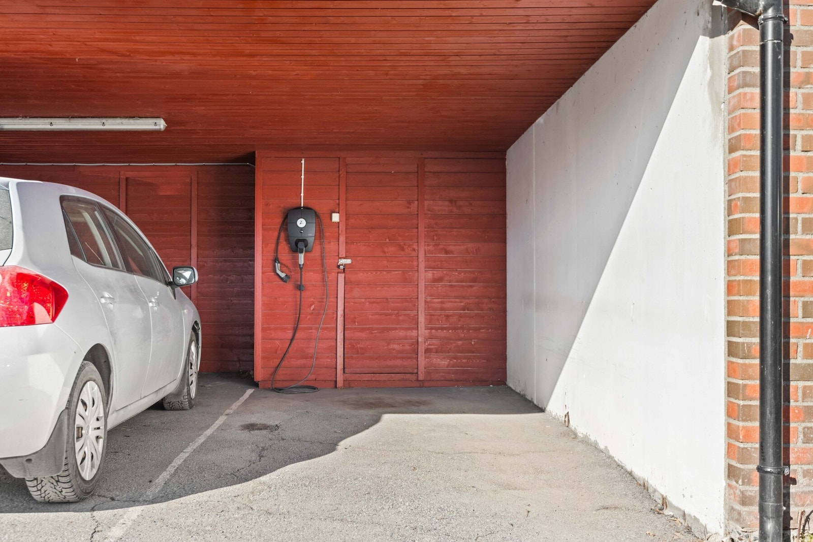 Boligen har en parkeringsplass i felles carport med el/bil lader. Bak parkeringsplassen ligger boden på 5 kvm. Galleribilde