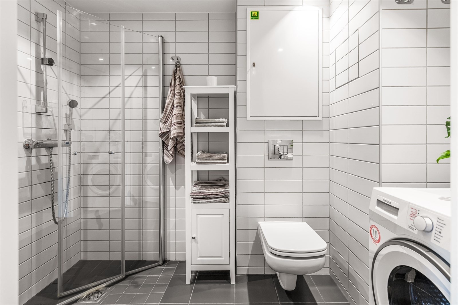 Flislagt bad med opplegg for vaskemaskin. Galleribilde