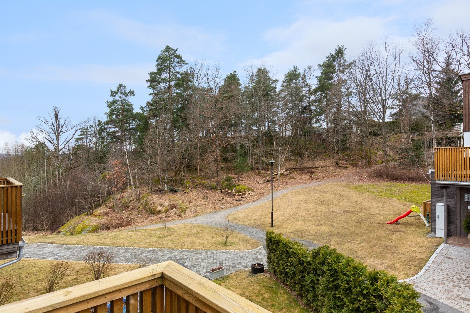 Utsikt mot skog og tursti fra terrassen i 2.etasje. Galleribilde