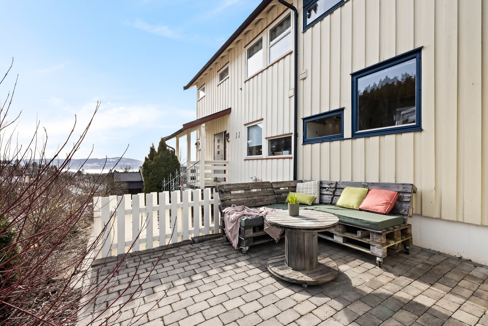 Hyggelig uteplass belagt med belegningsstein - ved siden av inngangspartiet Galleribilde