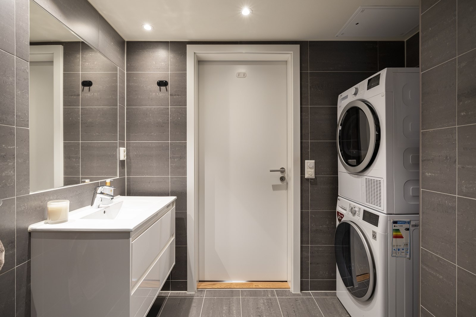 Det er praktisk opplegg for vaskemaskin og tørketrommel i egen nisje, noe som gjør rommet både praktisk og funksjonelt. Galleribilde
