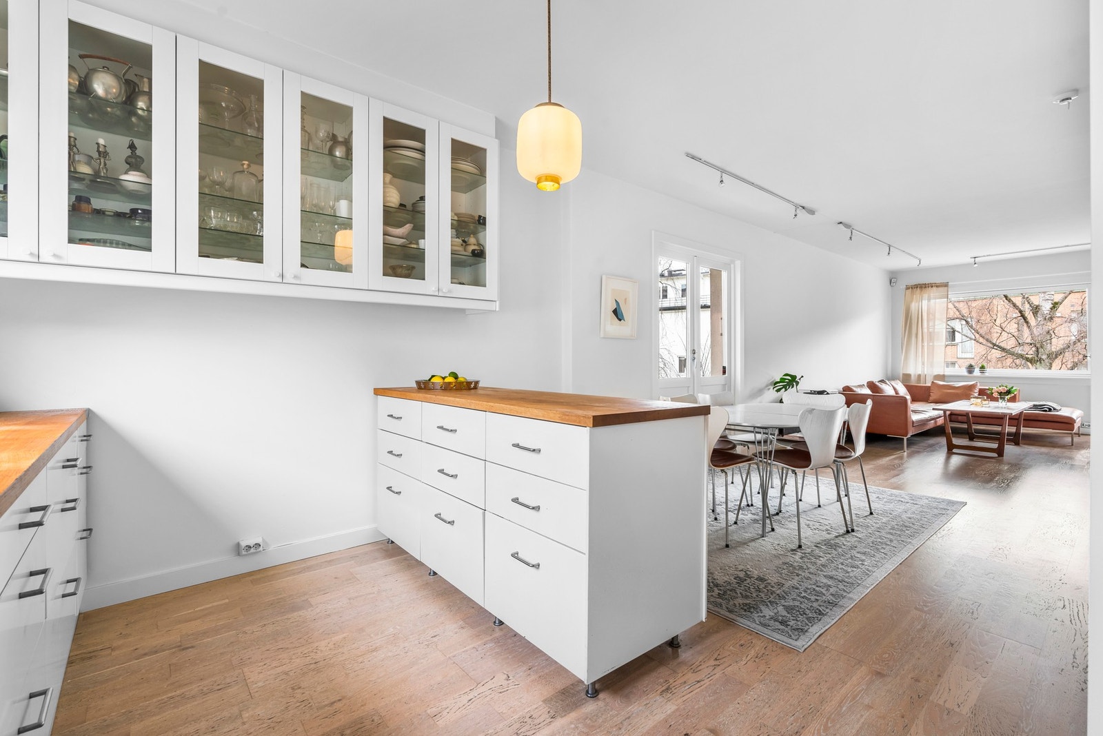 Frittstående kjøkkenøy og spiseplass deler naturlig kjøkkenet fra stuedelen Galleribilde