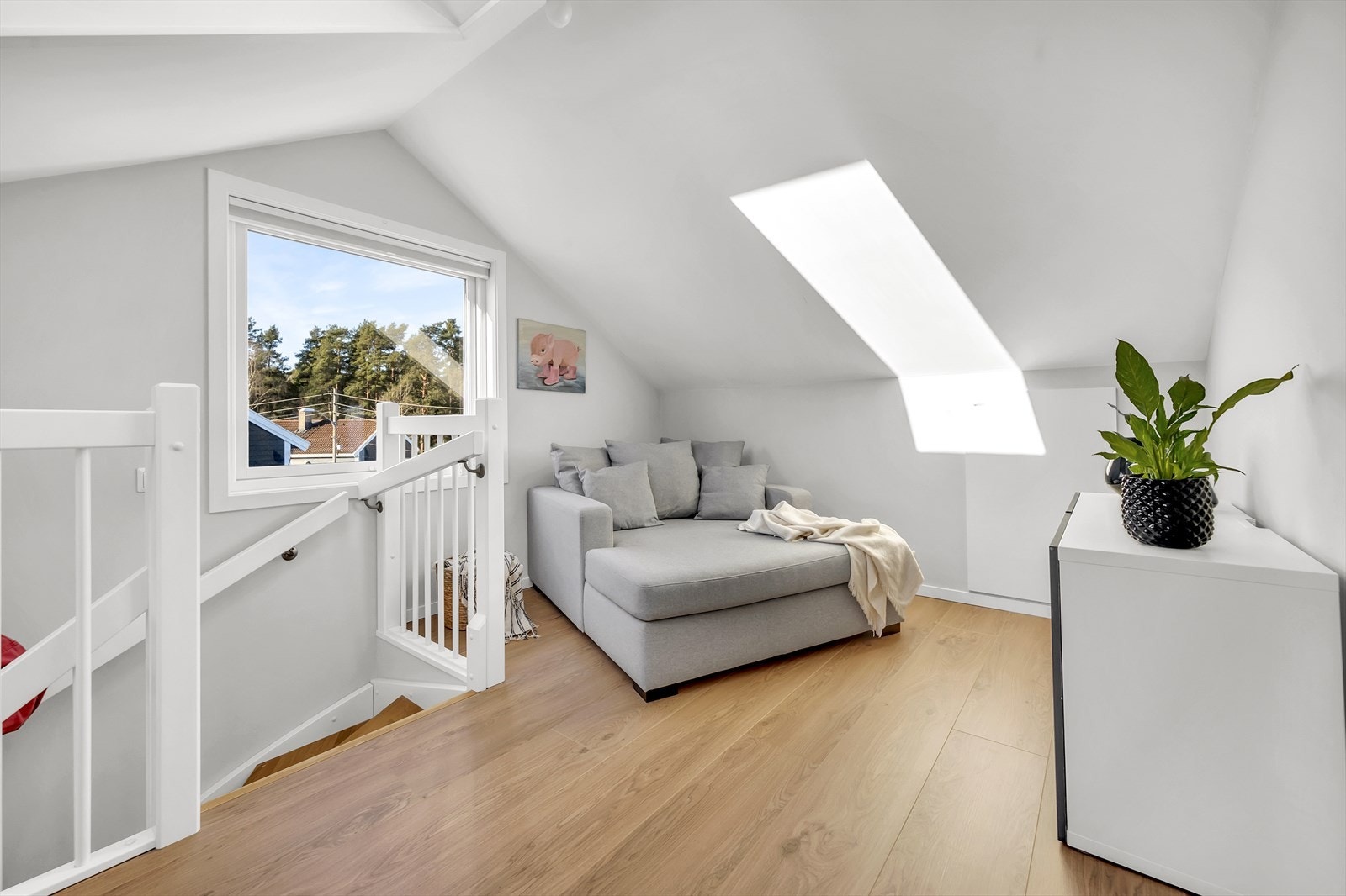 Her har du leilighetens andre stue med godt med naturlig lys fra flere vinduer! Det er også ekstra lagring bak døren/luken ved sofaen. Galleribilde