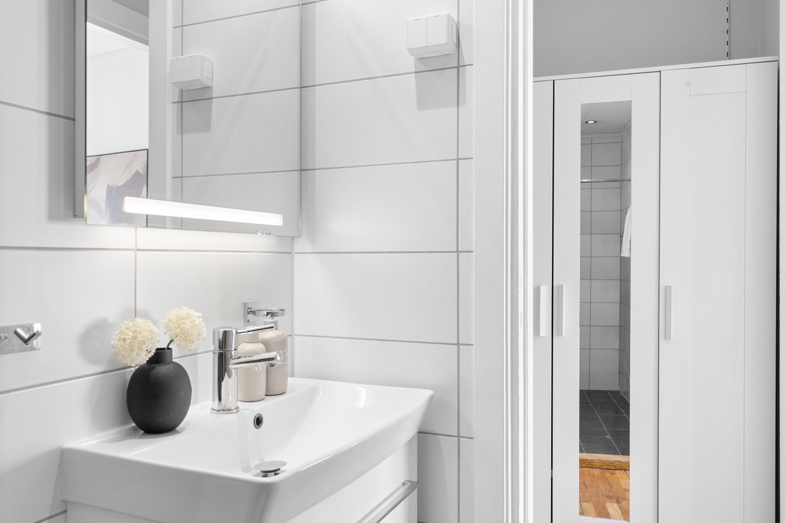 Badet har vegghengt toalett og dusjhjørne Galleribilde