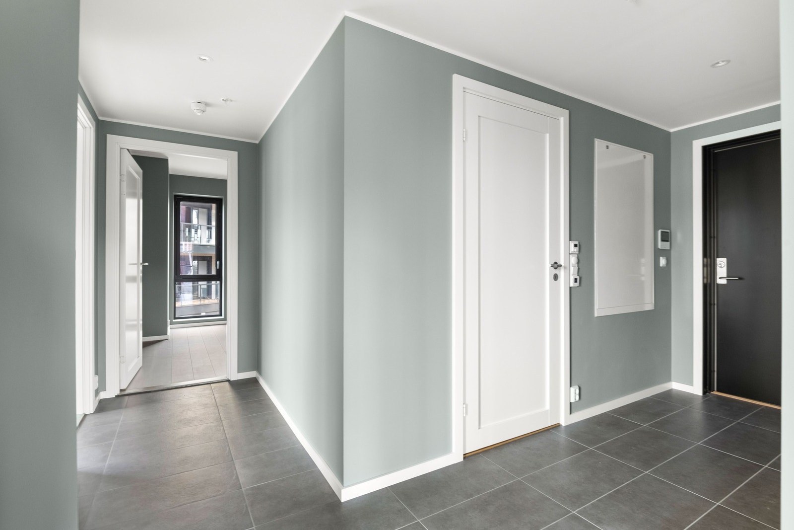 Leiligheten har en romslig hall med flislagt gulv og vannbåren gulvvarme, noe som er gjennomgående for hele boligen med unntak av våtrom. Galleribilde