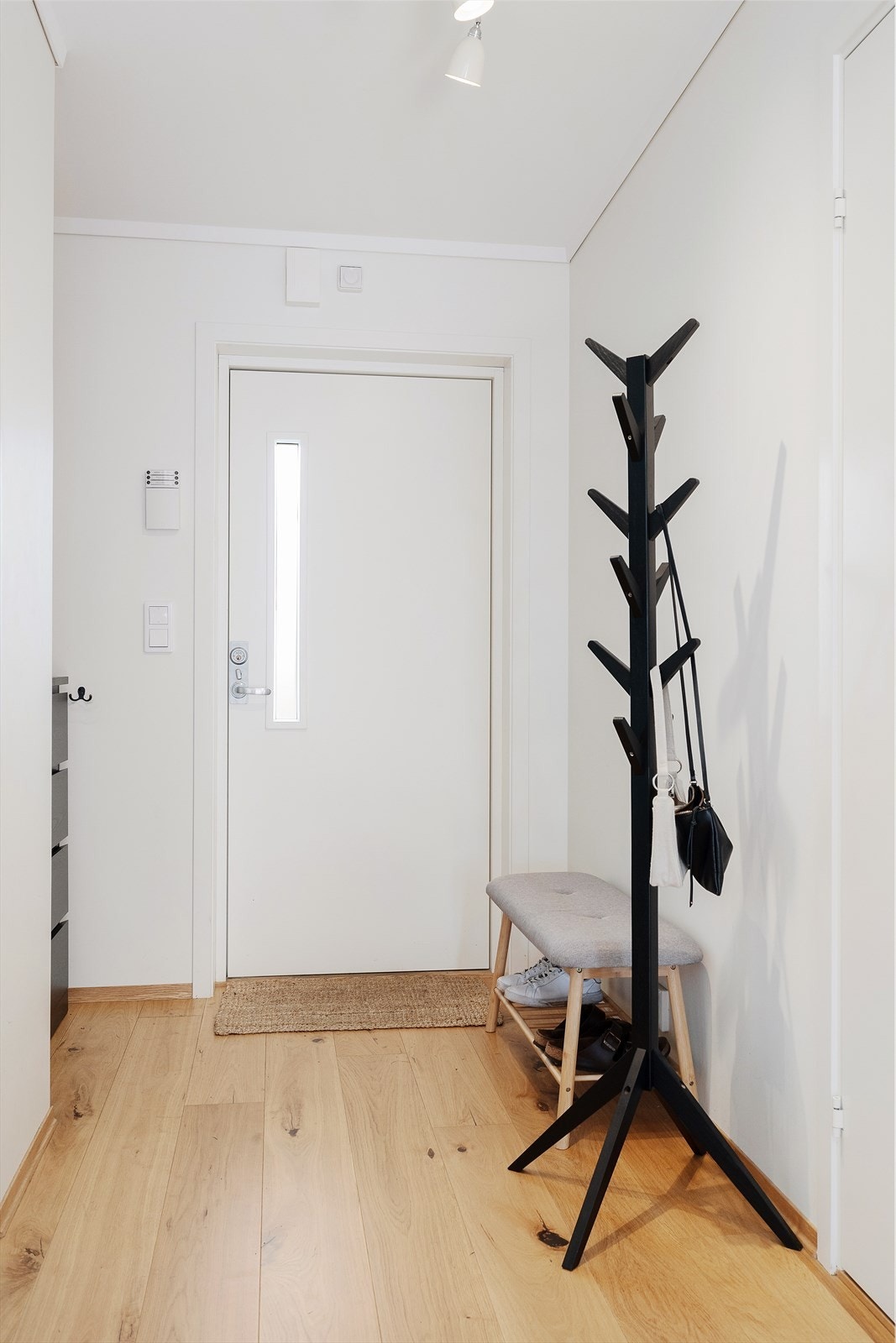Entreen har lyse vegger og parkett på gulvet, her er det plass til å henge fra seg yttertøy. Galleribilde