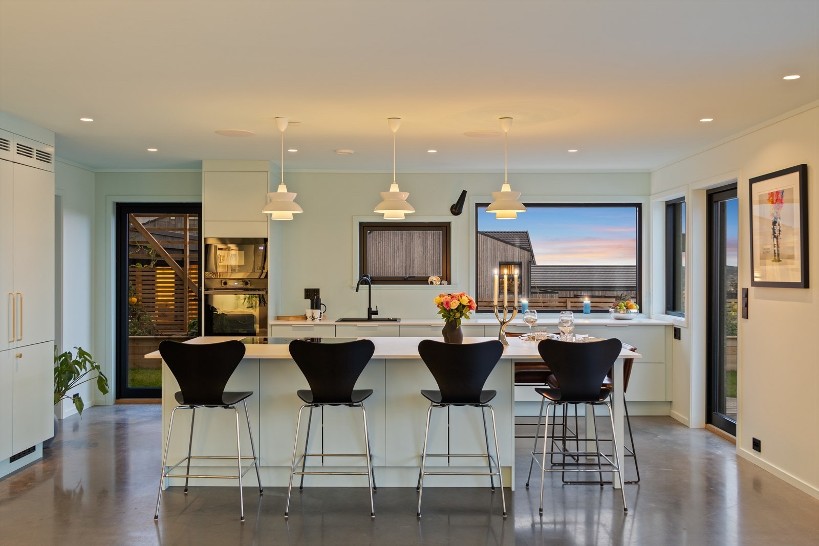 Meget behagelig stemning med god belysning og nydelig utsikt fra de store vindusflatene på kjøkkenet Galleribilde