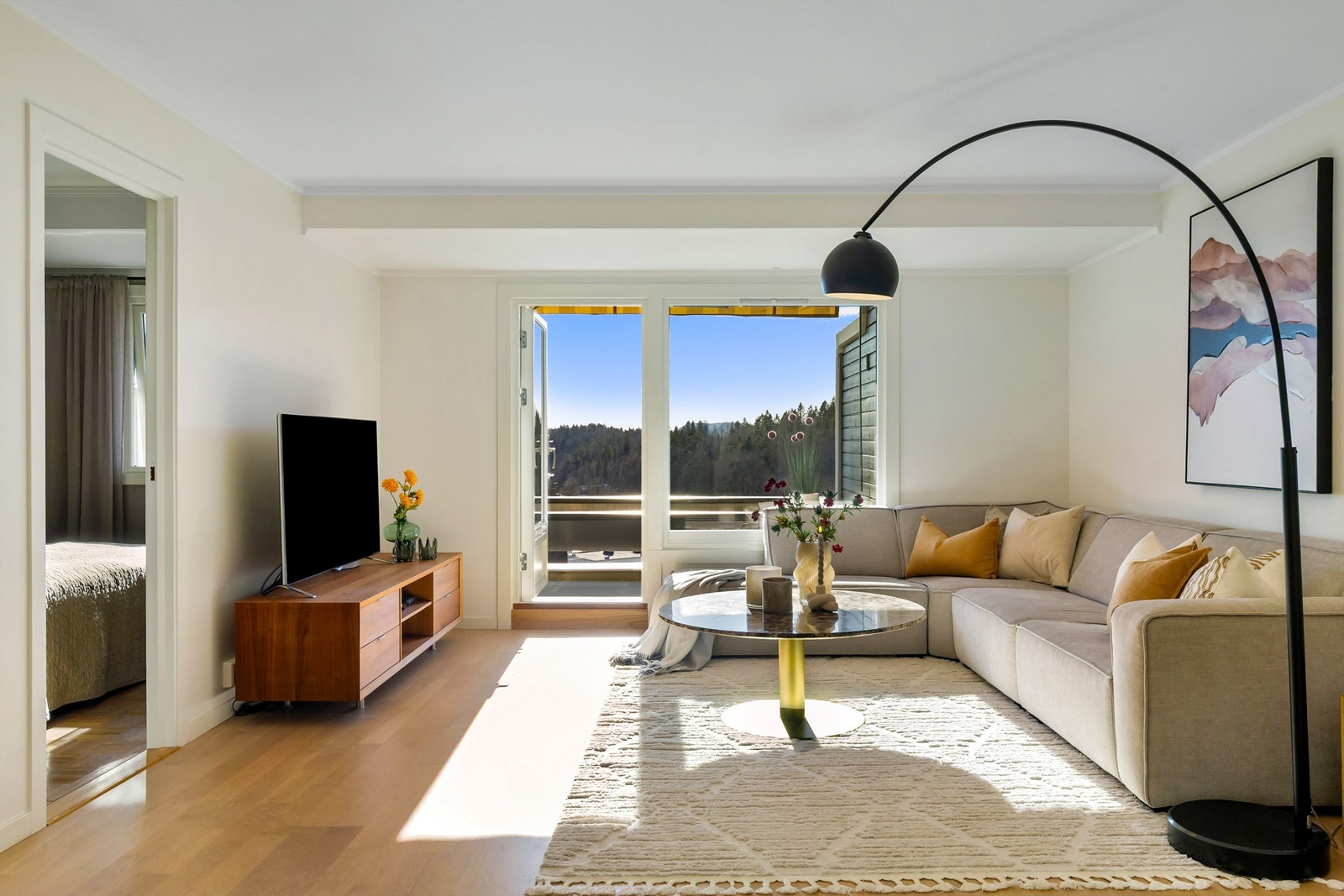 Svært lys og hyggelig stue hvor de store vinduer gir mye naturlig lys inn i leiligheten Galleribilde