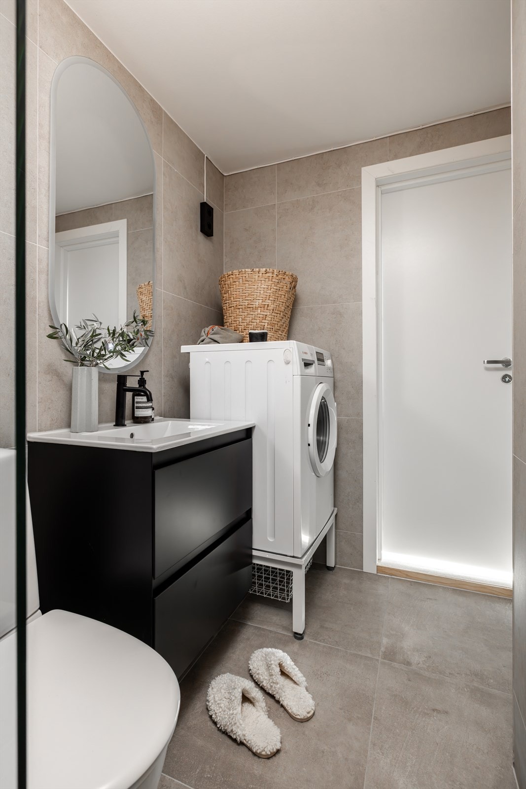 Ny innredning med nedfelt servant, toalett, dusjvegger/hjørne og opplegg for vaskemaskin. Galleribilde