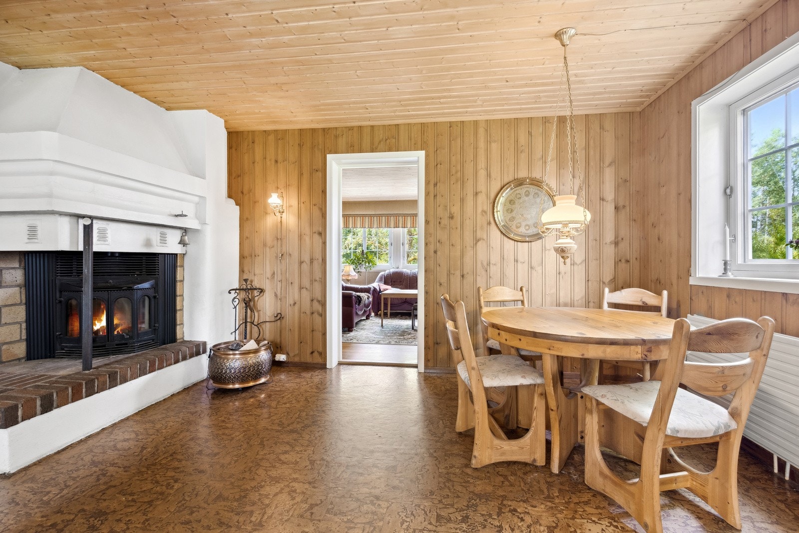 I den ene enden av det koselige kjøkkenet er det spiseplass og en stor peis med innsats som gjør det ekstra hyggelig. Galleribilde
