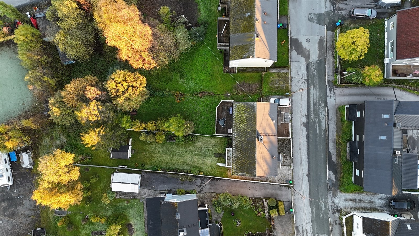 Rett ned mot eiendommen. Det er biloppstillingsplass på tomten, slik at man slipper å parkere i gaten, slik mange må gjøre i dette området. I tillegg en passelig fin størrelse på hagen som er opparbeidet med plen. Galleribilde