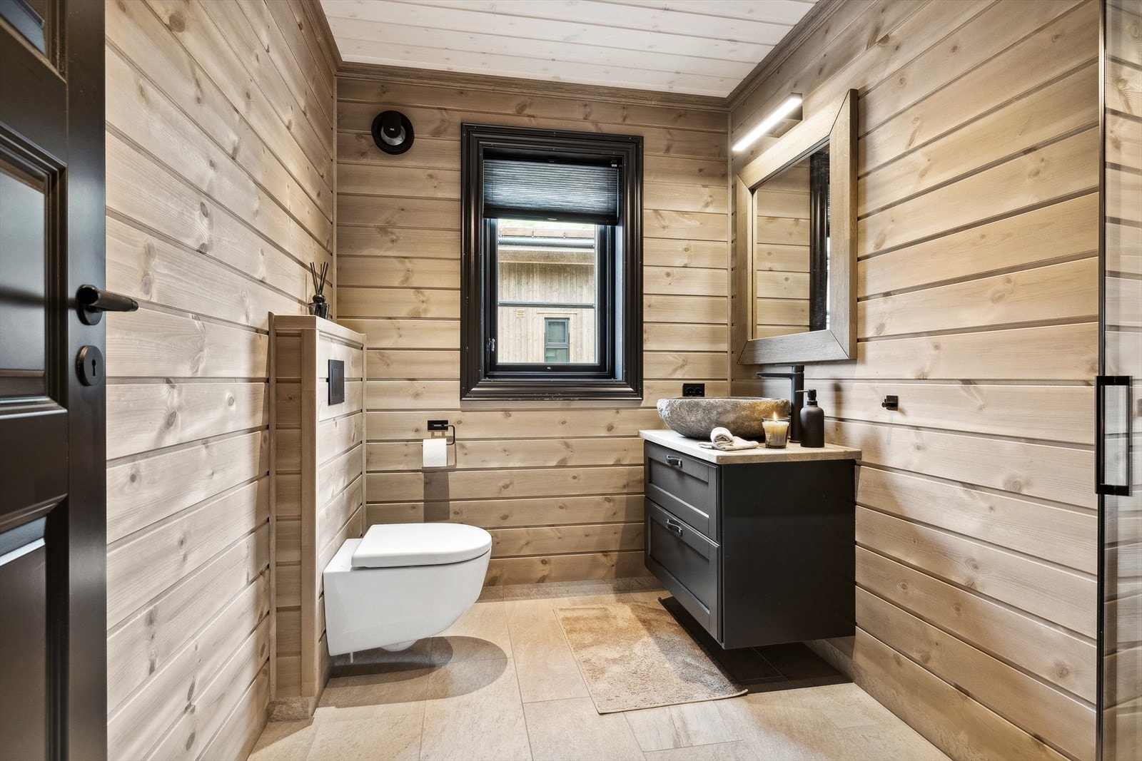 Baderom 2 har fliser på gulv og i dusjsonen, panel på vegger og i himling. Galleribilde