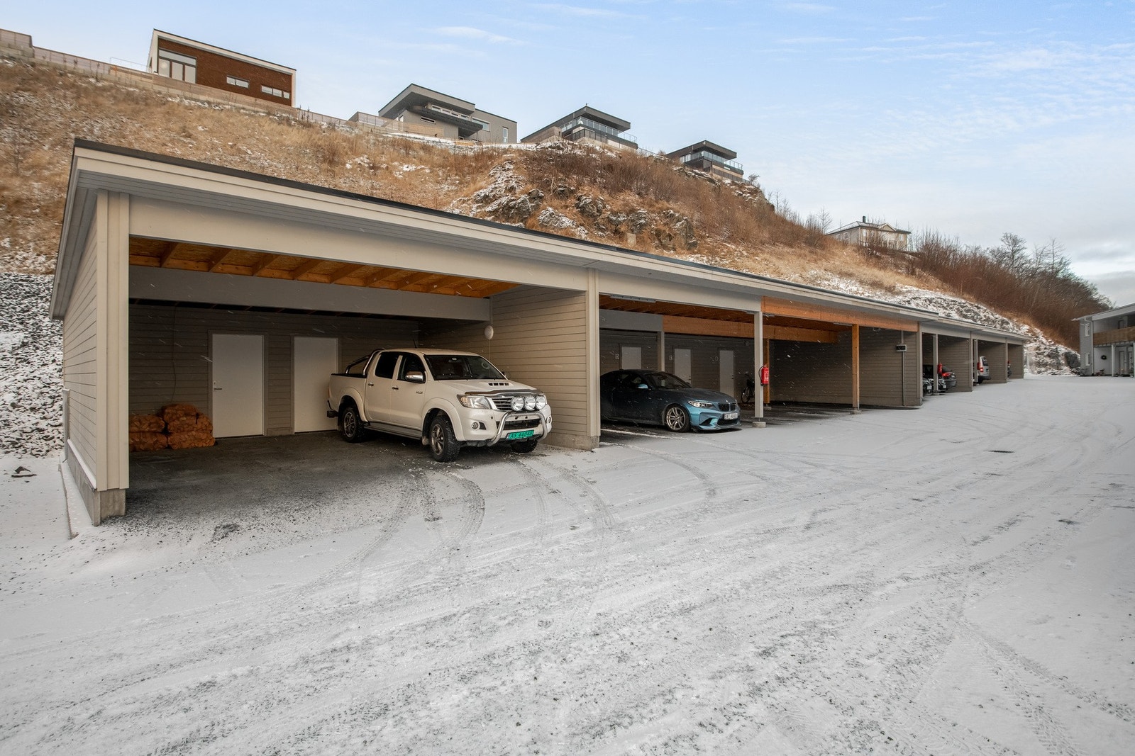 Parkering i carport med bod i bakkant. Galleribilde