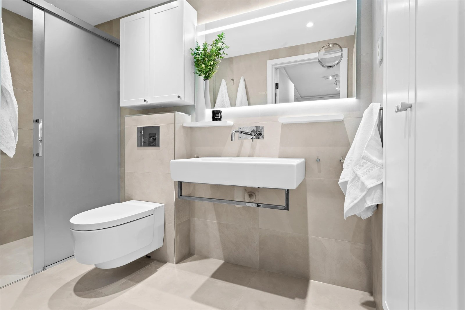 Lekkert bad med stor dusj med skyvedører i frostet glass. Galleribilde