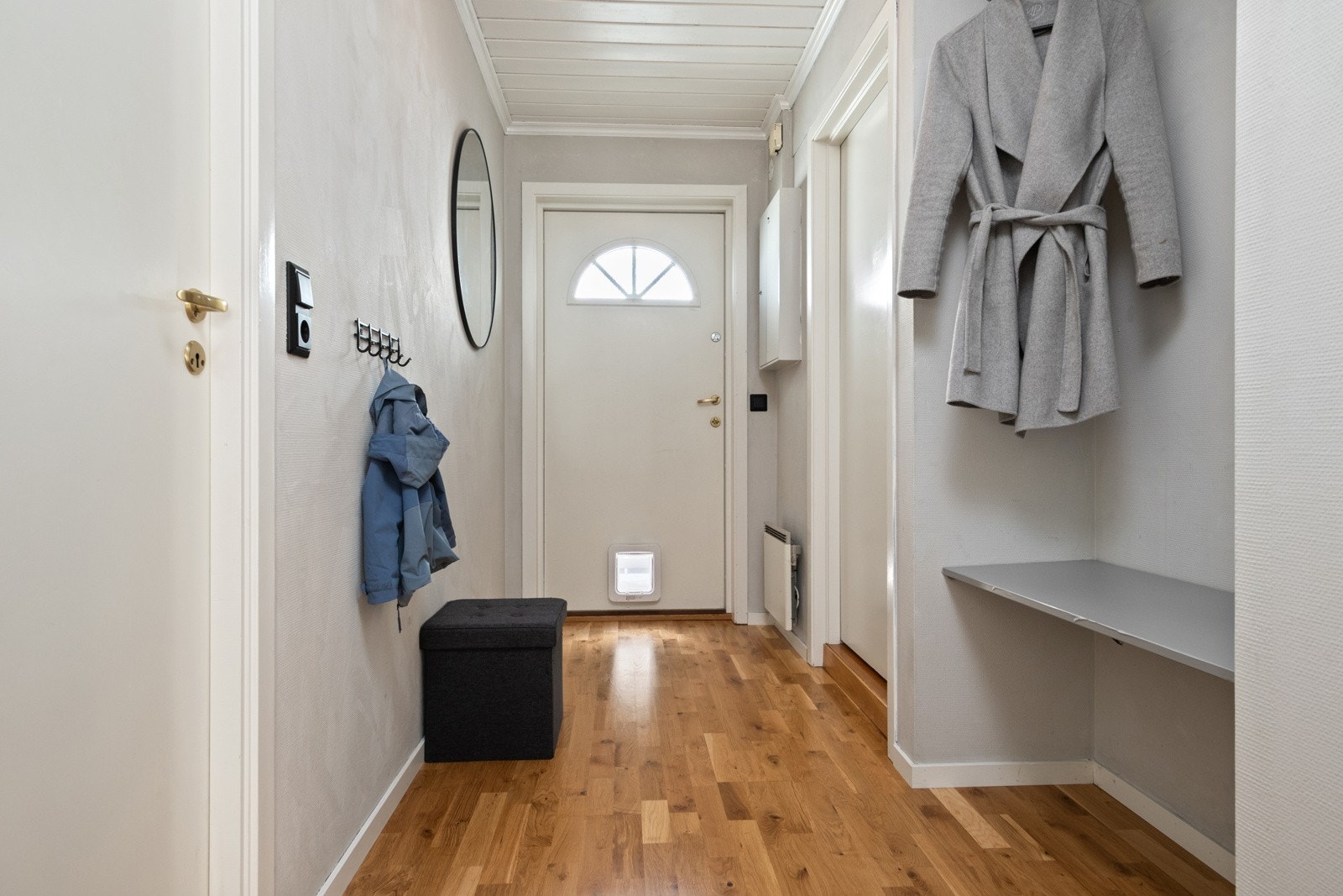 Vel inne blir vi ønsket velkommen i en fin entré med lysmalte vegger og gyllent parkettgulv. Galleribilde