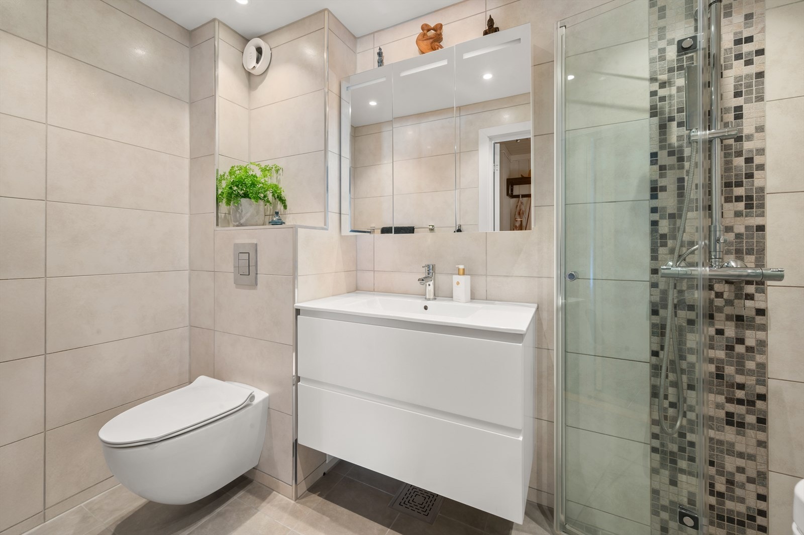 Pent flislagt baderom med varmekabler i gulv og downlights i himling. Galleribilde