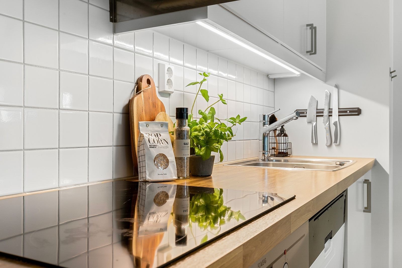 Kjøkkenet har delikate fliser på vegg bak innredning og en velholdt benkeplate av laminat. Galleribilde
