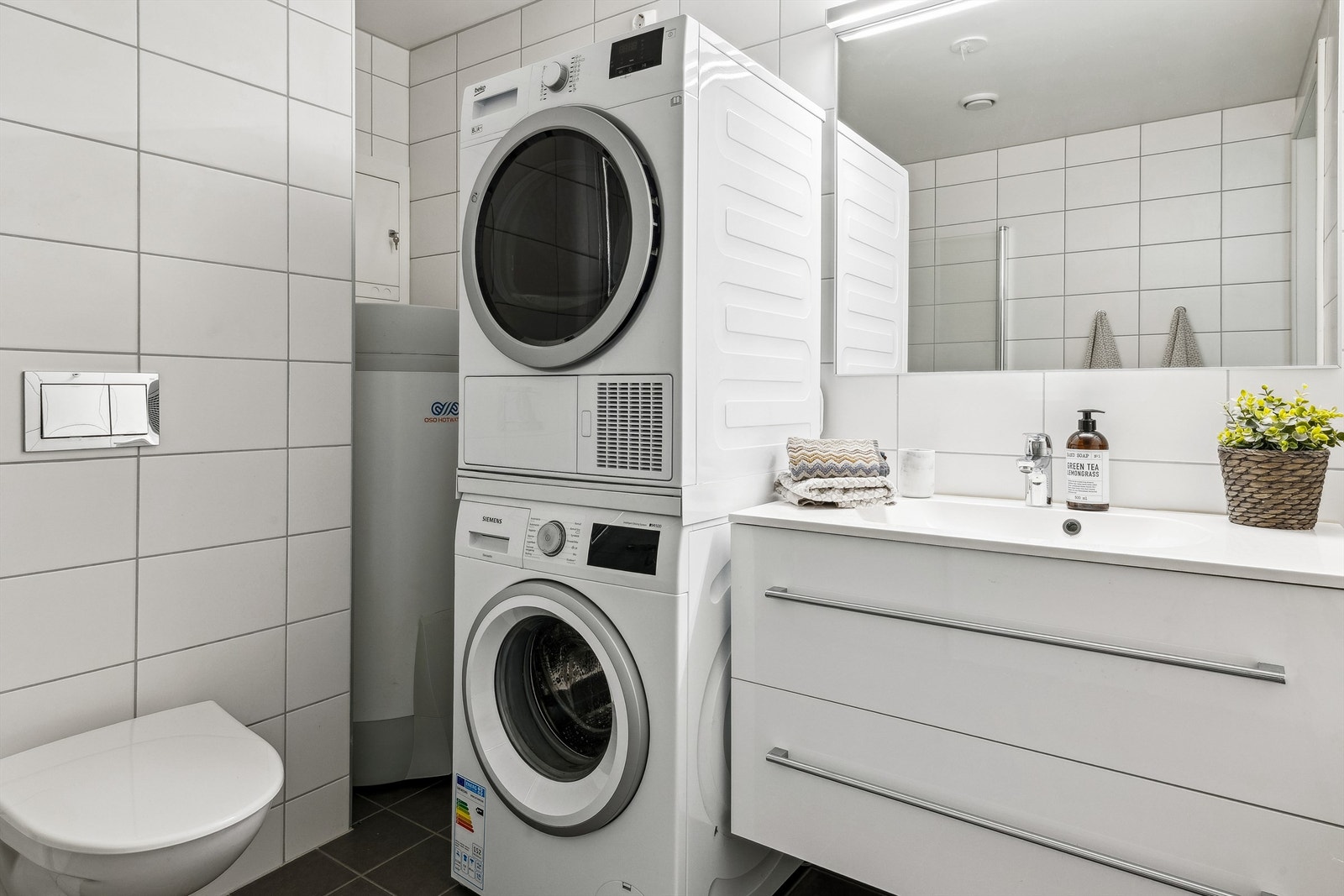 Badet er innredet med vegghengt toalett og dusjhjørne med glassdører samt innredning med servant Galleribilde