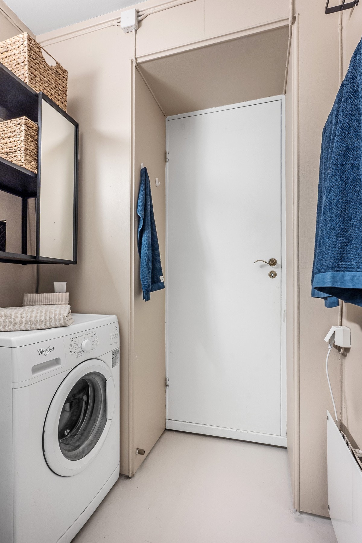 Badet har opplegg for vaskemaskin og er naturlig plassert bak døren Galleribilde