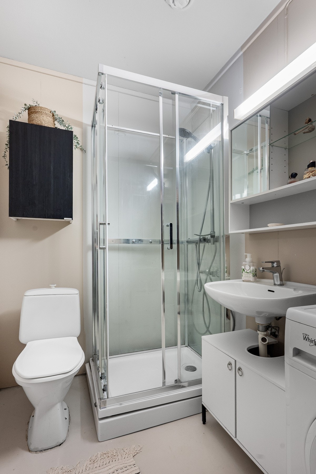 Badet består av frittstående wc, servant, overskap m/speilfronter og overlys, veggskap og hyller samt dusjkabinett. Galleribilde