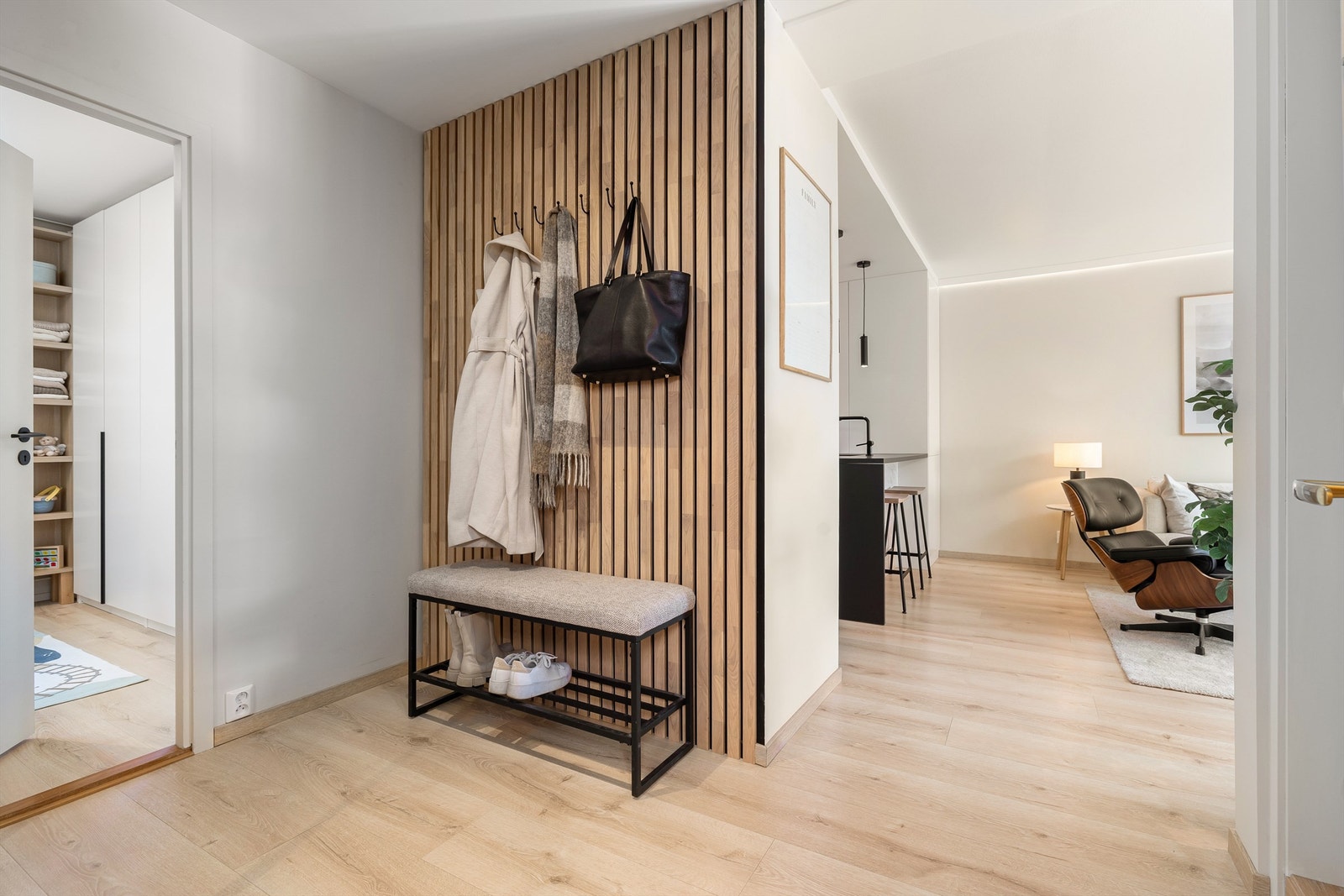 Romslig og innbydende entré med lekker spilevegg med oppheng for ytterklær samt stort garderobeskap med speilfronter. Galleribilde