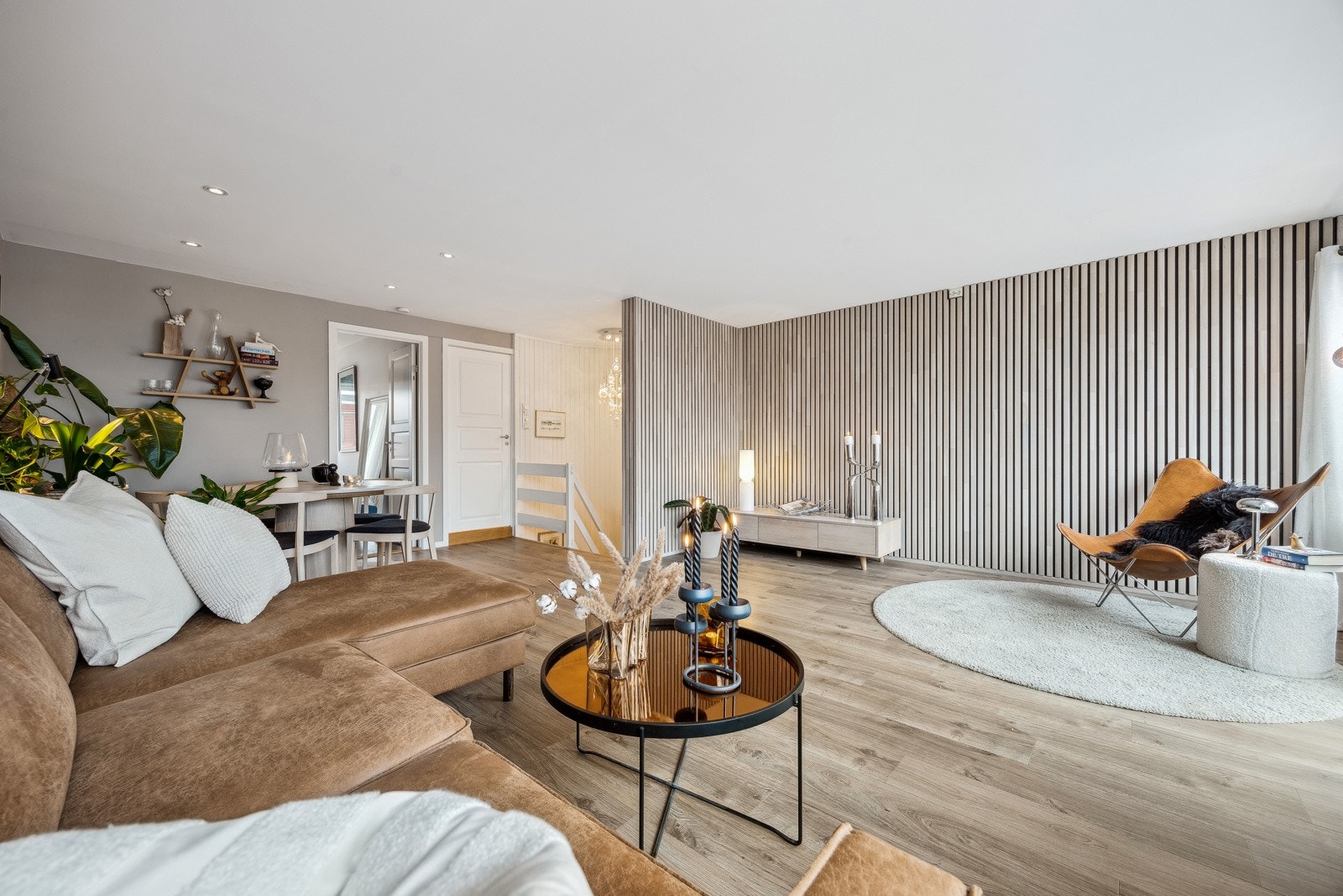 Tar man trappeløpet opp til 2. etasje ankommer man boligens stueareal. Interiøret er moderne med nøytrale fargevalg på vegger, en stilren spilevegg og utstrakt bruk av downlights. Galleribilde