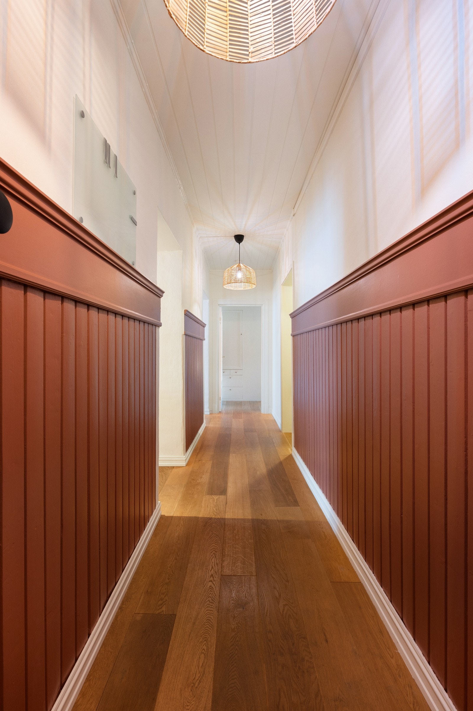 Veggene har klassisk brystningspanel i en varm fargetone, kombinert med lyse overflater som gir en fin balanse mellom tradisjon og modernitet Galleribilde