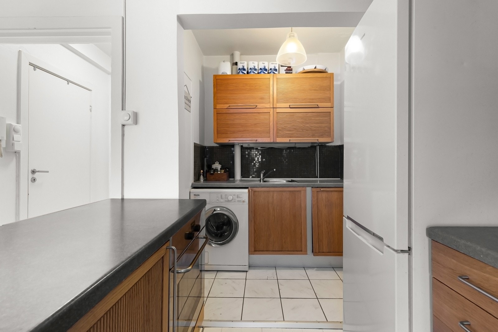 Det er integrerte hvitevarer med platetopp, stekeovn, oppvaskmaskin og nisje for kjøleskap, samt nisje for vaskemaskin. Galleribilde