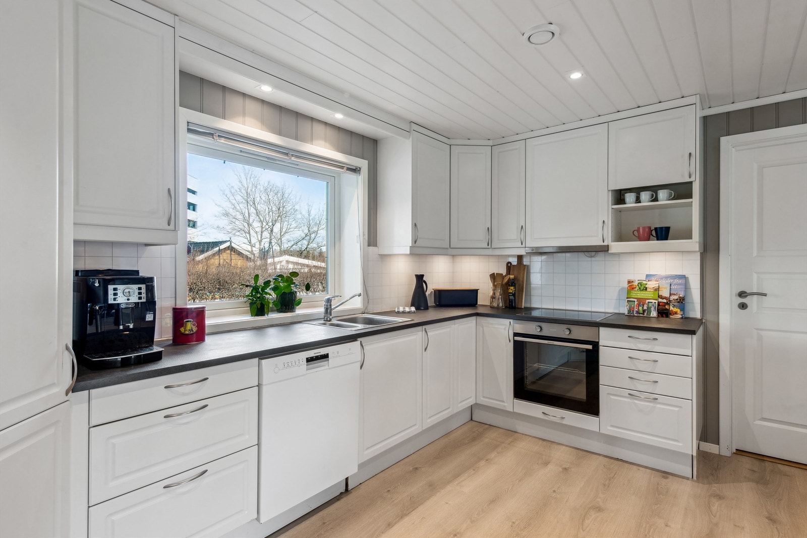 Innvendige ioverflater består av: gulv med laminat, vegger med malte plater, malt tapet og malt panel og himlinger med malt MDFpanel og folierte plater. Galleribilde