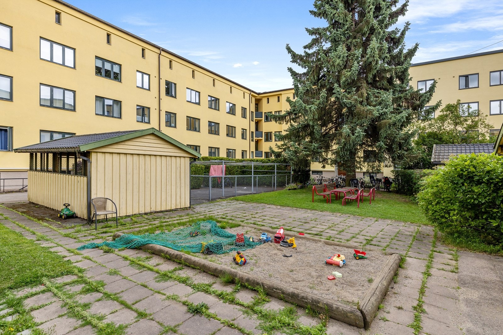 Bakgård med sitteplasser, tørkemuligheter og barnevognsparkering. Galleribilde