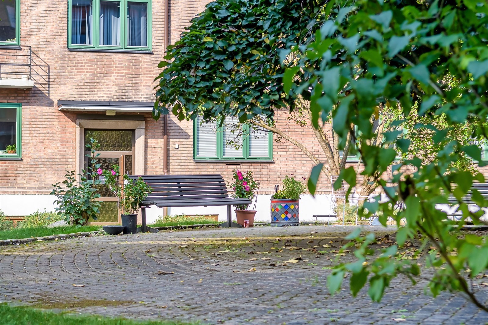 Hyggelig bakgård med flotte grøntarealer og flere sittegrupper Galleribilde