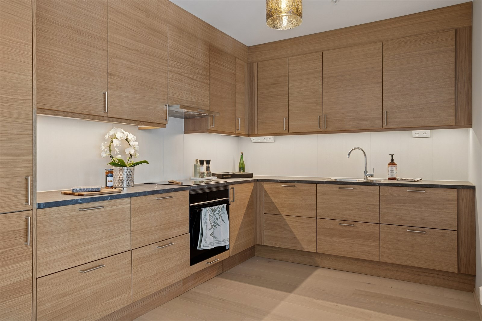 Pent kjøkken fra Marbodal. Flis over benkeplate og integrerte hvitevarer. Galleribilde