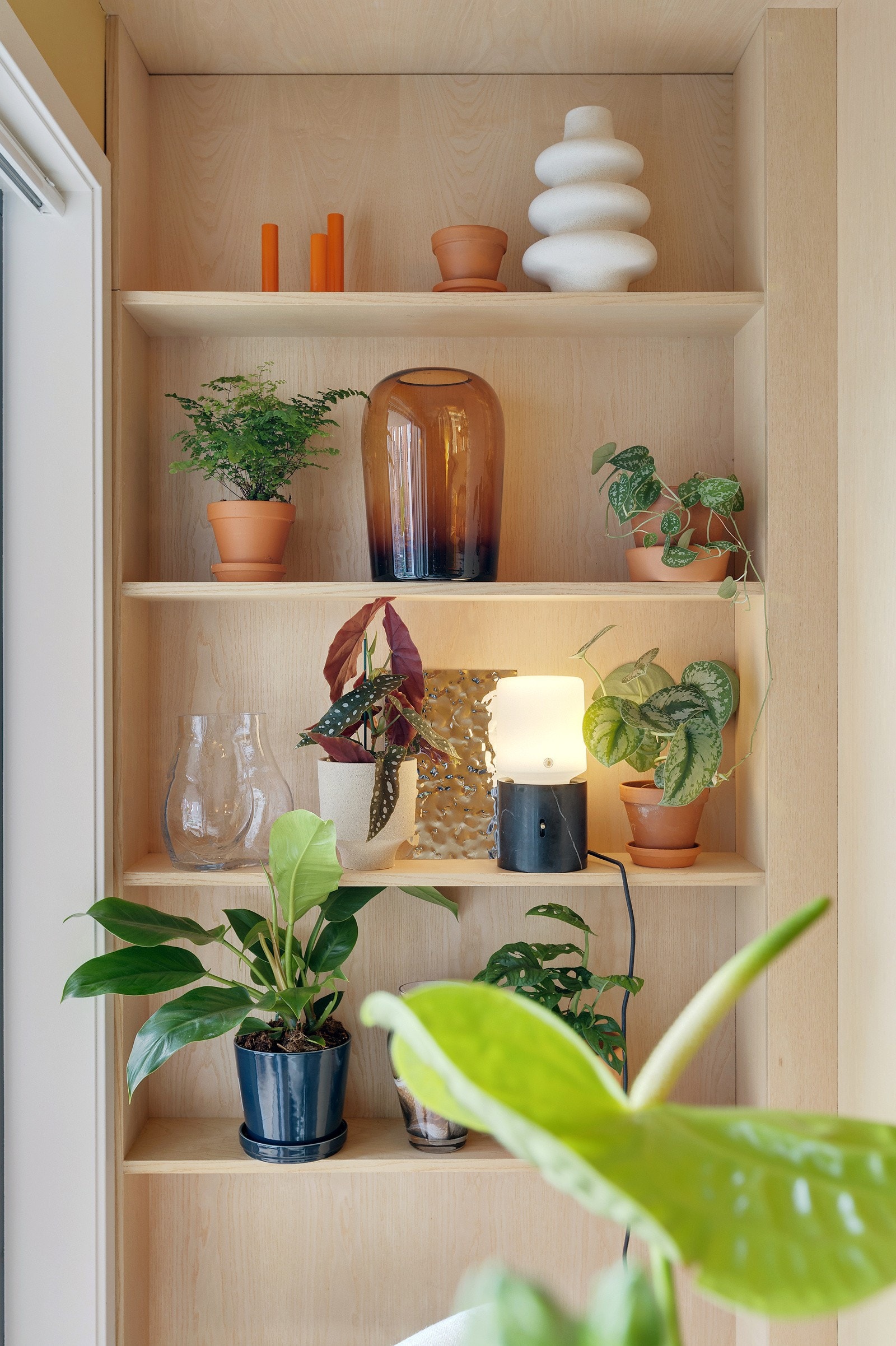 Leiligheten er full av smarte løsninger med blant annet denne dekorative plassbygde hyllen i eikefinér. Galleribilde