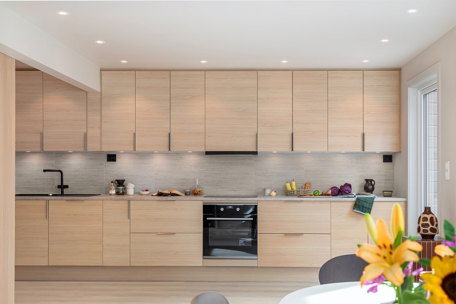 Moderne Aubo kjøkkeninnredning fra 2025 med integrerte hvitevarer fra Electrolux, samt stilren Røroshetta. Galleribilde