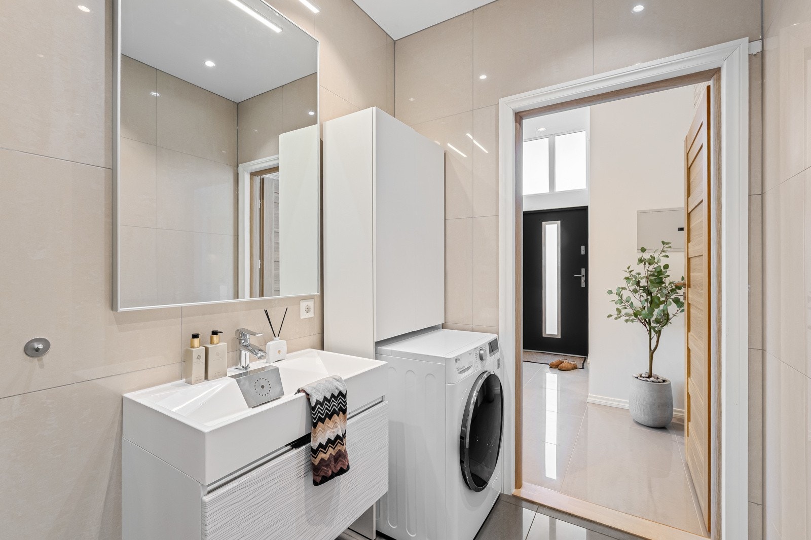 Det er et lekkert bad innredet med heldekkende servant m belyst speil. Galleribilde